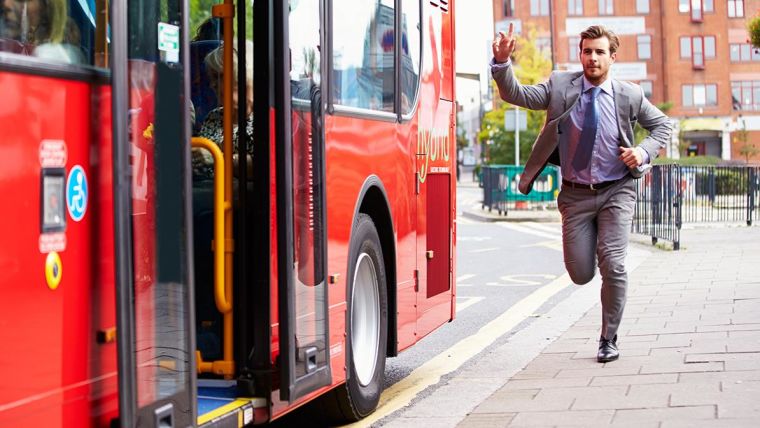 A man running to catch a bus