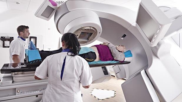 Radiologist treating cancer patient with radiotherapy