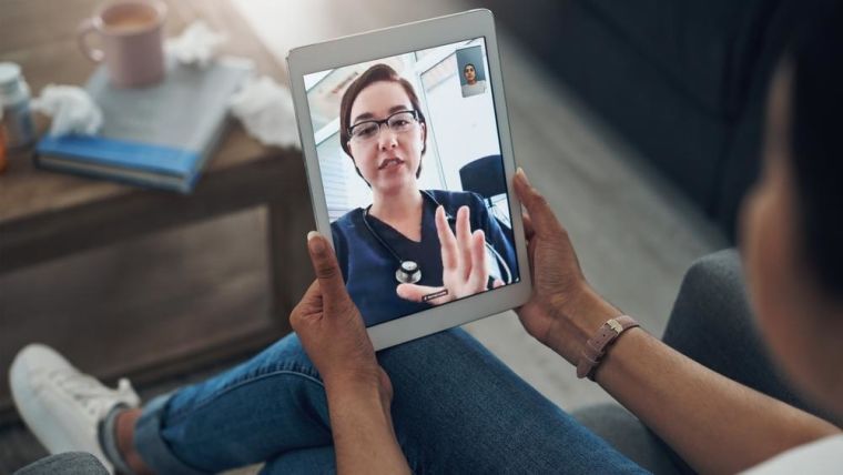 A remote GP consultation taking place on a tablet with patient at home