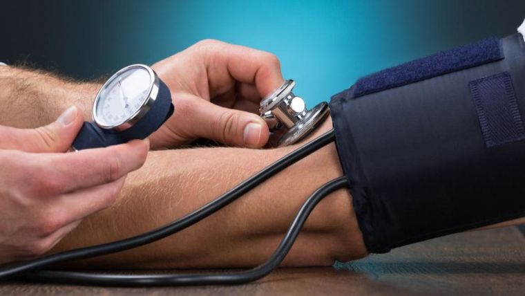 Close up of doctor taking a patients blood pressure on arm