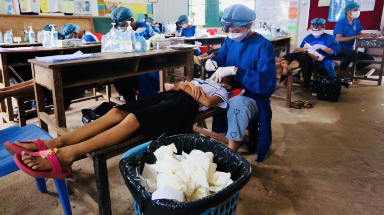 A dental doctor and final year dentistry students volunteering in a dental screening drive stationed in Aung Run Primary School in Cambodia