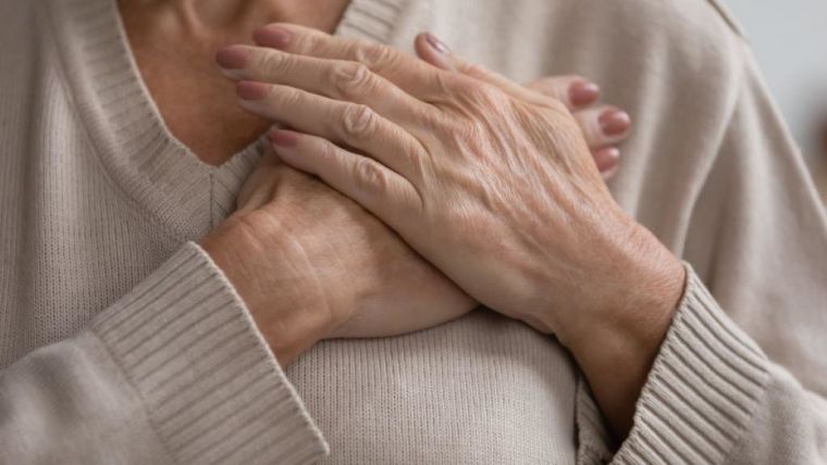 Woman holding her hands to her chest