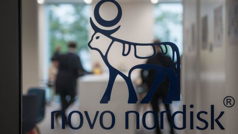 Logo of Novo Nordisk (a cow with a circle over its horns) on a glass door