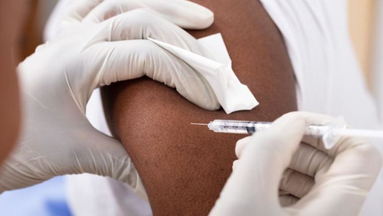 Example of a Close-up Of A Doctor Injecting Syringe To Male Patient's Arm In Clinic