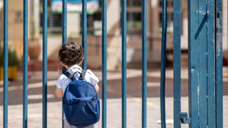 Primary school age child at school gates