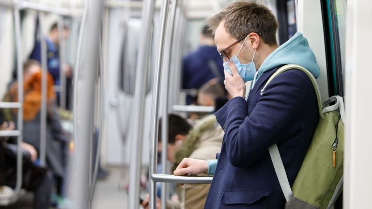 Man wearing a face mask on public transport