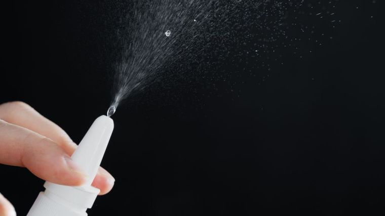 Close up of a spray bottle drops on black background