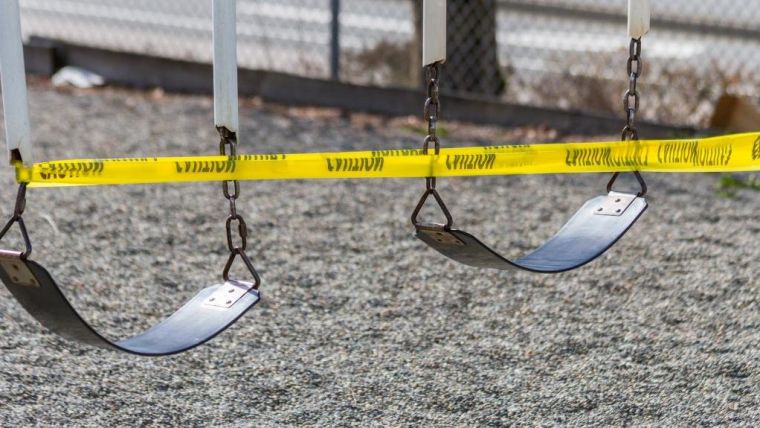 Swings taped off to prevent use with yellow 'caution' tape.